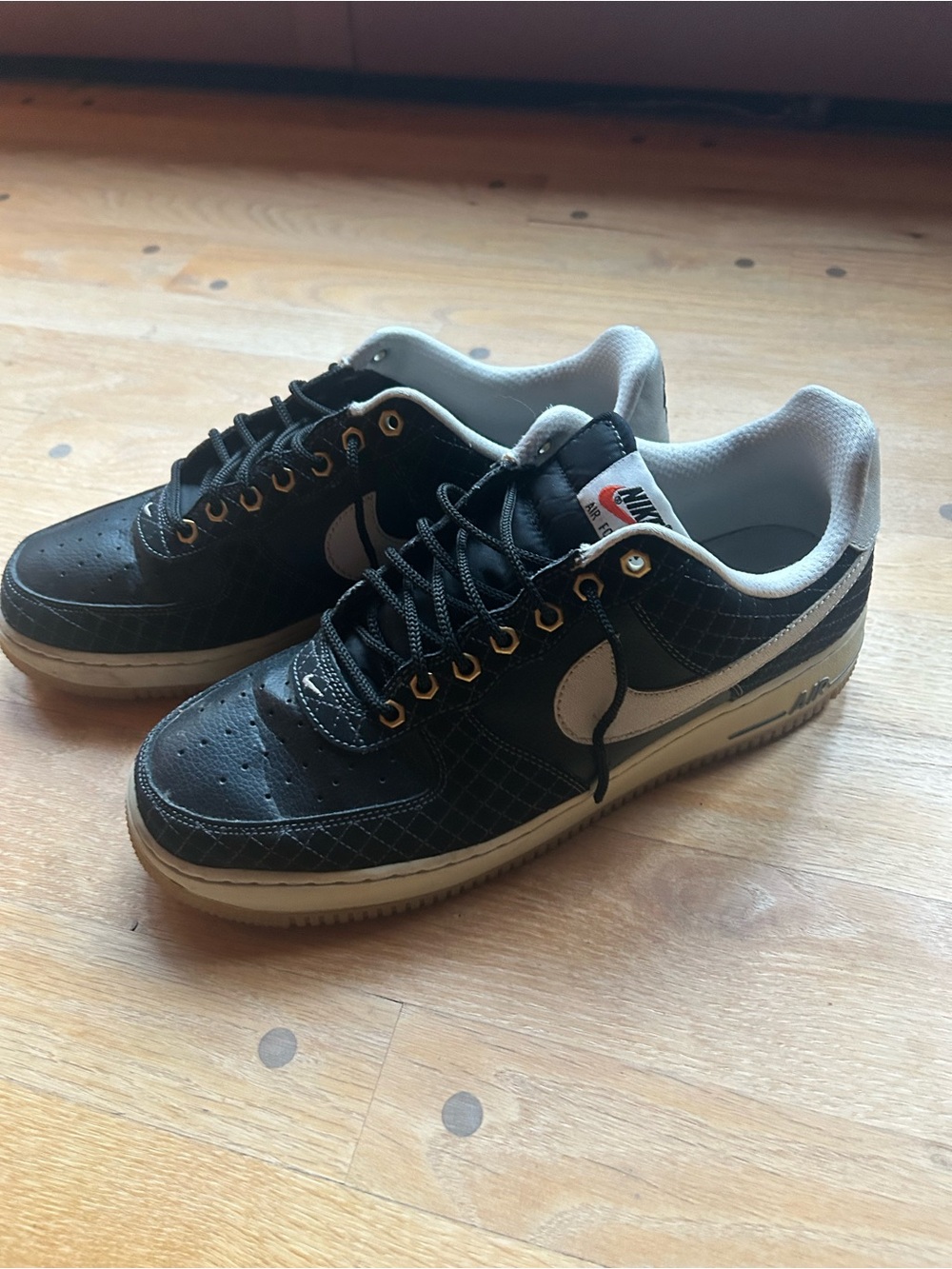 Nike Air Force 1 Black and Cream Low-Top Sneakers with Gold Eyelets